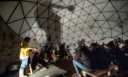 Des migrants assistent à un concert dans un théâtre de fortune de la "Jungle" de Calais, dans le Pas-de-Calais, le 25 novembre 2015