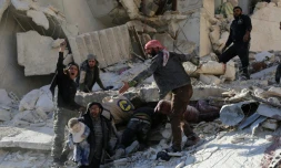 Des civils et des secouristes cherchent des victimes dans les décombres d'un bâtiment à la suite de frappes aériennes gouvernementales à Alep le 7 décembre 2015