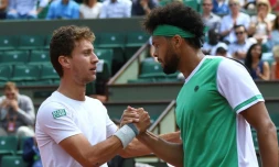 L'Argentin Renzo Olivo (g) serre la main de Jo-Wilfried Tsonga après sa victoire face au Français au 1er tour à Roland-Garros, le 31 mai 2017