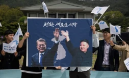 Les photos du président sud-coréen Moon Jae-in (g) et du leader nord-coréen Kim Jong-Un lors d'un rassemblement pour la paix, le 26 avril 2018 à Séoul