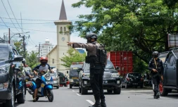 Un policier indonésien régule la circulation aprÚs un attentat suicide visant une église, à Makassar, en Indonésie, le 28 mars 2021