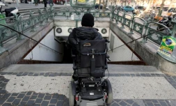 Une personne en fauteuil roulant devant les escaliers d'une bouche de métro, le 19 février 2013 à Paris