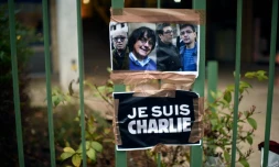 Portraits de quatre des victimes de l'attaque contre Charlie Hebdo, devant le siège de l'hebdomadaire satirique le 8 janvier 2015 à Paris