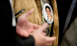 Un membre de la famille d'Anne Barbot porte le portrait de la victime en médaillon, le 14 janvier 2016 au palais de justice de Nantes