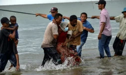 Des pĂȘcheurs du village de Lancok, dans la rĂ©gion d'Aceh, en IndonĂ©sie, aident des Rohingyas arrivĂ©s par bateau, le 25 juin 2020