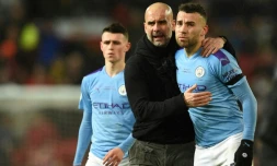 L'entraĂźneur de Manchester City Pep Guardiola conseille Nicolas Otamendi lors d'un match de Premier League face Ă Manchester United, Ă Old Trafford, le 8 mars 2020