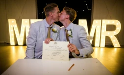 Australian athletes Craig Burns (L) and Luke Sullivan (R) kiss after their marriage ceremony at Summergrove Estate, New South Wales on January 9, 2018