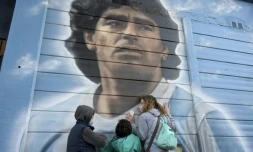 Des personnes se recueillent devant une fresque murale de Diego Maradona, peinte par l'artiste Marley, le 22 juin 2021 à Buenos Aires