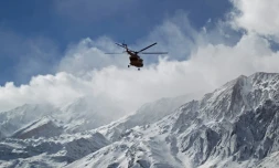 Une photo distribuée par l'agence de presse iranienne Tasnim montre un hélicoptÚre de secours survolant les monts Zagros pour retrouver l'épave d'un avion de ligne qui s'est écrasé dimanche, le 19 février 2018