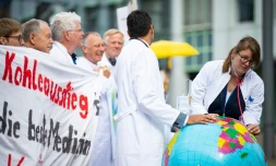 Deux médecins de l'organisation "Doctors For Future" ausculent une Terre en baudruche lors d'une manifestation pour la protection du climat en marge d'un congrÚs de médecins à Munster (nord-ouest de l'Allemagne), le 28 mai 2019