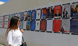 Une Tunisienne passe devant des affiches de campagne des candidats à la présidentielle, le 7 septembre 2019 à Tunis