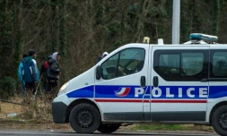 Des migrants et une voiture de police à Calais, le 3 mars 2017