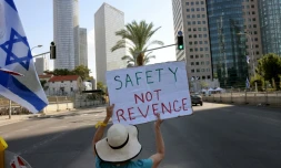 Une Israélienne brandit une pancarte réclamant "Sécurité, pas de vengeance", le 16 octobre 2023, pendant un sit-in permanent à Tel Aviv devant le ministÚre de la Défense depuis le massacre perpétré en Israël le 7 octobre par le Hamas qui a fait 1.400 morts, surtout des civils israéliens