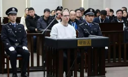 Photo fournie par le tribunal populaire de Dalian, en Chine, le 14 janvier 2019 du Canadien Robert Lloyd Schellenberg (C) pendant son procès pour trafic de drogue