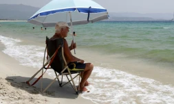 Un homme sous un parasol à plage à Ajaccio le 19 juillet 2023