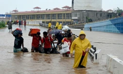 Des habitants d'Acapulco marchent dans une rue inondée après le passage de l'ouragan John à Acapulco dans l'Etat du Guerrero, dans le sud du Mexique, le 27 septembre 2024