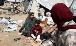 Une famille palestinienne déplacée, dont des membres ont été blessés lors de frappes israéliennes, devant sa tente à Deir el-Balah, dans le centre de la bande de Gaza, le 13 avril 2025