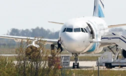 Un homme quitte l'Airbus A-320 de la compagnie EgyptAir qui stationne sur le tarmac de l'aéroport de Larnaca à Chypre le 29 mars 2016 après son détournement