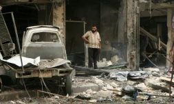 Un Syrien au milieu des ruines après des frappes de l'armée de l'air le 21 septembre 2015 à Alep