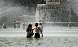 Des enfants se rafraßchissent dans les bassins de la fontaine du Trocadéro lors d'un épisode de fortes chaleurs, le 22 juillet 2019 à Paris
