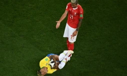 Le Brésilien Neymar au sol sous les yeux du Suisse Valon Behrami, agacé, lors du Mondial, le 17 juin 2018 à Rostov