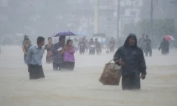 Des habitants de la ville de Pégou en Birmanie dans les rues inondées de leur ville, le 29 juillet 2018