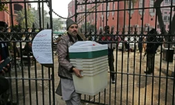 Un homme récupère du matériel électoral dans un centre de distribution à Lahore le 7 février 2024, un jour avant les élections nationales au Pakistan