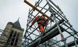 Un employé travaille sur la façade de la cathédrale de Saint-Denis pendant les travaux de reconstruction de la flèche, le 4 février 2025 près de Paris