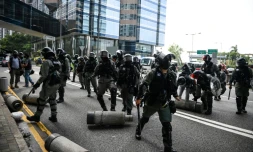 Police clear barricades left by protestors. Clashes between police and activists were less intense than at the start of October when the city was virtually shut down