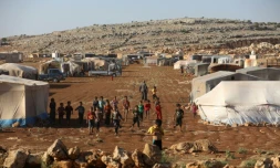 Des enfants se rassemblent dans un camp pour les déplacés à Kafr Dariyan, dans la province syrienne d'Idleb, le 26 août 2018 