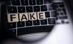 L'inscription "fake" (faux vue à travers une loupe sur un clavier à Mulhouse, France, le 1er décembre 2023