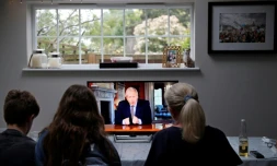 Une famille regarde une allocution télévisée du premier ministre britannique, Boris Johnson, à Hartley Wintney, à l'ouest de Londres, le 10 mai 2020