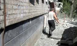 Un homme enjambe un obus non explosé à Lyssytchansk (Ukraine), le 21 juin 2022