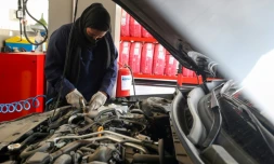 Une Saoudienne réparant une voiture dans un garage à Jeddah, le 26 mai 2022