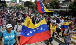 Des militants de l'opposition participent à une marche, le 23 janvier 2019 à Caracas, au Venezuela