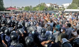 Des forces de sécurité tentent de repousser des manifestants devant le Parlement à Tunis, le 26 juillet 2021