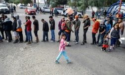Des migrants d'Amérique centrale essayant de pénéterr aux Etats-Unis font la queue pour une distribution de nourriture à Tijuana au mexique le 15 novembre 2018