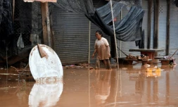 Des habitants retournent chez eux après les inondations provoquées par l'effondrement d'un barrage, le 26 juillet 2018 à Sanamxai, dans la province d'Attapeu, au Laos