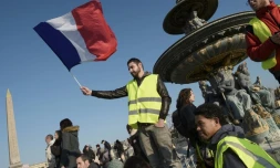 Un manifestant "gilet jaune" tient un drapeau français lors d'un rassemblement place de la Concorde, le 17 novembre 2018 à Paris