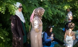 Des femmes attendent à Bapska en Croatie à la frontière avec la Serbie, le 23 septembre de monter dans des autobus pour les conduire dans un centre de transit