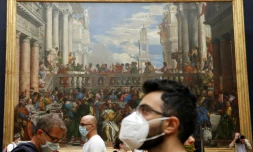Des visiteurs devant les Noces de Cana de Veronese, au Louvre, le 6 juillet 2020, jour de sa réouverture aprÚs plus de trois mois de fermeture