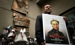 Un homme tient un portrait de la journaliste russe Anna Politkovskaïa assassinée le 7 octobre 2006 lors d'une manifestation à Moscou, le 7 octobre 2014