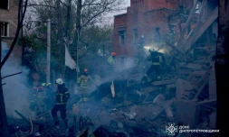 Photo prise et diffusée par le Service d'État des situations d'urgence de l'Ukraine, le 25 avril 2026, montrant des secouristes dans les décombres d'un immeuble résidentiel après une attaque russe à Dnipro, dans le centre-est du pays 