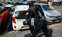 Un policier d'une unité spécialisée de terrain fouille un dealer présumé dans un quartier nord de Marseille, le 31 mars 2023