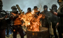 Des migrants se réchauffent autour d'un feu dans la "jungle", le 1er mars 2016 à Calais
