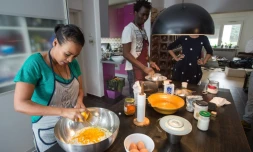 Chichi Amare (g), originaire d'Ethiopie, et David Ajobi, un ancien étudiant en médecine du Nigeria, préparent du pain le 27 octobre 2015 à Zagreb, dans le cadre d'un projet qui vise à aider les migrants à s'installer dans un nouveau pays