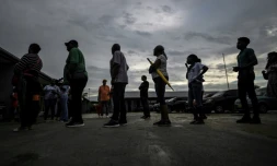 Des électeurs attendent pour voter lors des élections législatives, le 25 mai 2025 à Paramaribo, au Suriname