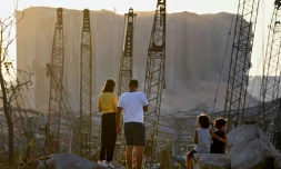 Un couple et des enfants regardent les dommages causés il y a dix jours par l'explosion du port de Beyrouth, le 13 août 2020