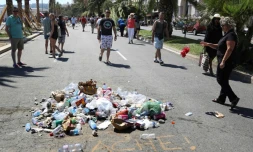 Des passants jettent le 18 juillet 2016 des dĂ©tritus Ă l'endroit oĂč aurait Ă©tĂ© tuĂ© Mohamed Des passants jettent le 18 juillet 2016 des dĂ©tritus Ă l'endroit oĂč a Ă©tĂ© tuĂ© Mohamed Lahouaiej-Bouhlel, prĂšs de l'inscription "LĂąche!" sur le bitume