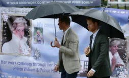 Les prince William et Harry regardent les hommages à leur mère Diana accrochés à la grille de Kensington Palace, où elle résidait à Londres, le 30 août 2017